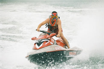 Man on jet ski wearing sports utility mask